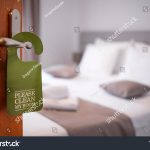 stock-photo-please-make-up-my-room-maid-cleaning-the-room-with-please-make-up-my-room-sign-on-the-door-opened-1913922382